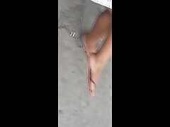 Candid ebony feet soles dangling in bus stop